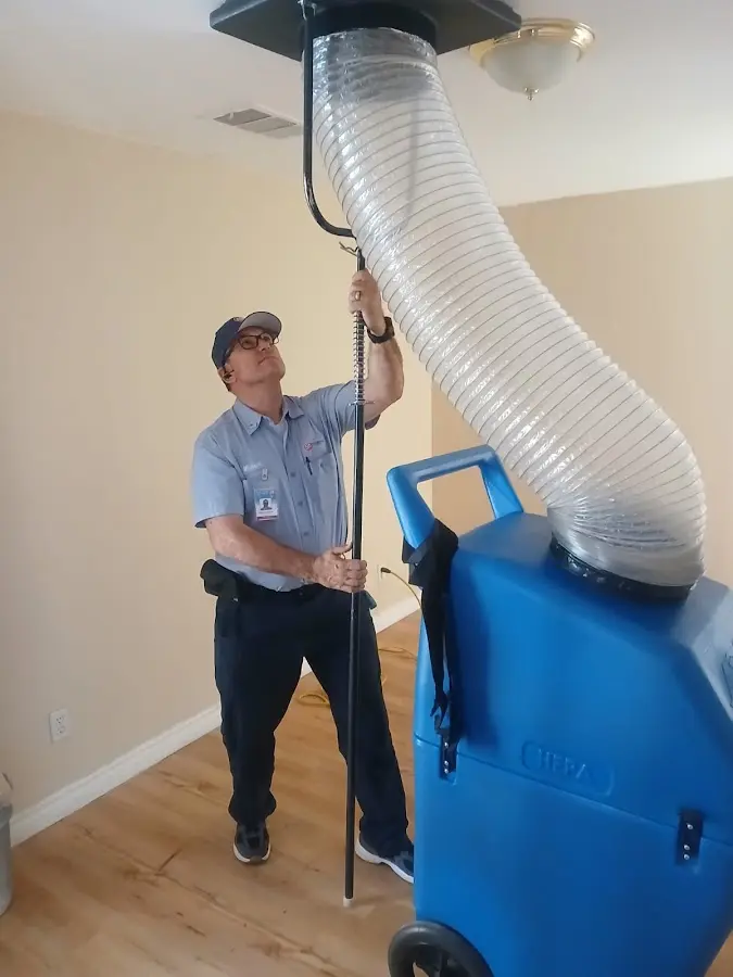 Furnace Tune-Up technician using HEPA equipment in Holmdel